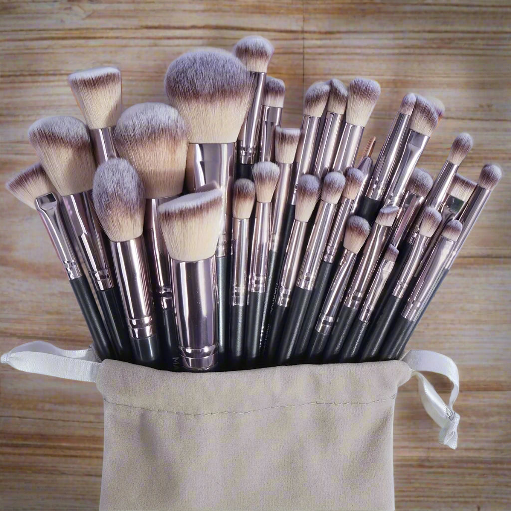 Set of makeup brushes in a beige pouch on a light blue background