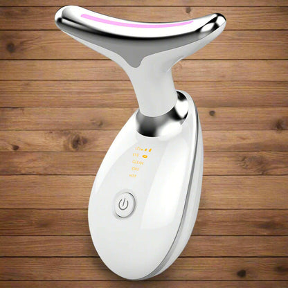 White and silver facial massager on a white background