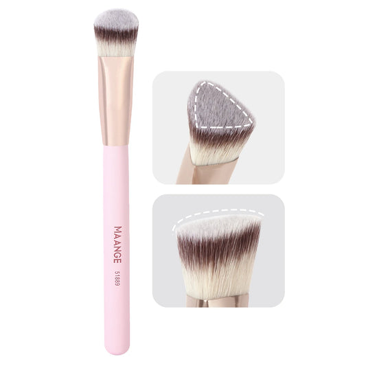 Makeup brush with pink handle and white bristle head on a white background